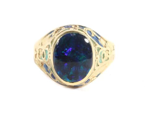 An Arts &amp; Crafts Black Opal and Enamel Signet Ring, an oval black opal in a rubbed over setting, to a tapering shank fill