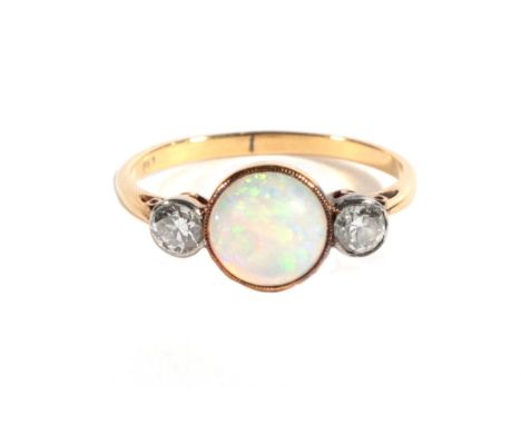 An Opal and Diamond Three Stone Ring, a grain set round cabochon opal, spaced by old cut diamonds, total estimated diamond we