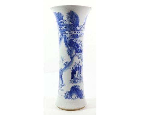 A Chinese Porcelain Beaker Vase, in Kangxi style, painted in underglaze blue with figures on a river bank within incised foli