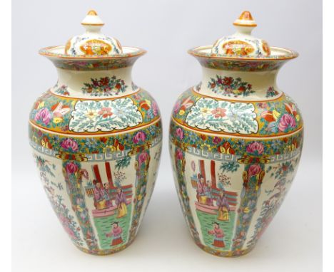 Pair Chinese Famille Rose style lidded jars printed with alternate panels of figures conversing in garden setting, matched co