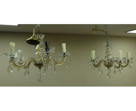 Two five light chandeliers, central glass column supporting five branches decorated with glass flower heads and prism drops, 