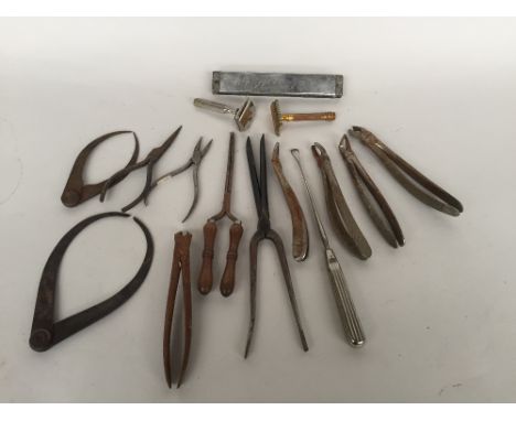 A collection of cast metal tools including pliers,calipers together with a harmonica and two razors (15)