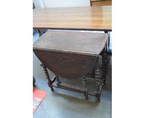 An oak gate leg table, early 20th century, on barley twist legs