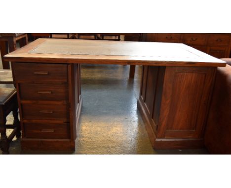 A teak kneehole desk with four drawers and a cupboard with internal shelf and leather skiver 90 x 153 x 75cm