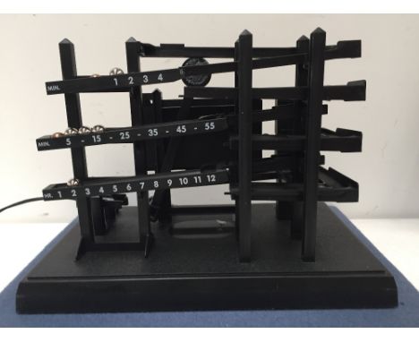 A Kugeluhr time machine clock by Mattel together with a silver plated John Lewis picture frame (picture size 20 x 25cm)