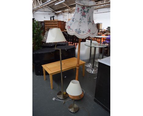 A brass adjustable standing lamp, a matching table lamp together with a beech standing lamp with turned base