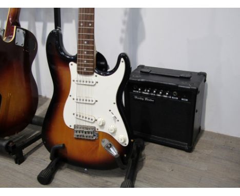 An unbranded stratocaster style electric guitar with sunburst paintwork, together with a Harley Benton amplifier and soft cas