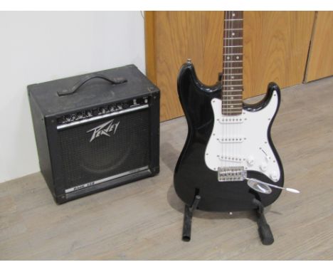 A C.Giant stratocaster style electric guitar in black together with a Peavey Rage 158 amplifier (2) 