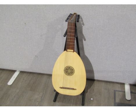 An EMS eight course lute, hard cased, with tuition books 