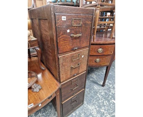 A vintage oak four drawer filing cabinet. H 134 W. 40 D.68cms