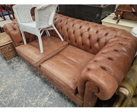 A leather upholstered Chesterfield sofa.