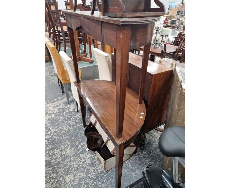 A pair of demi-lune tables, an occasional table, and a wall shelf.