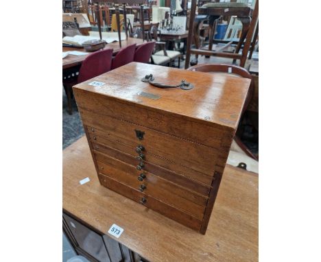 A vintage mahogany collector's chest.