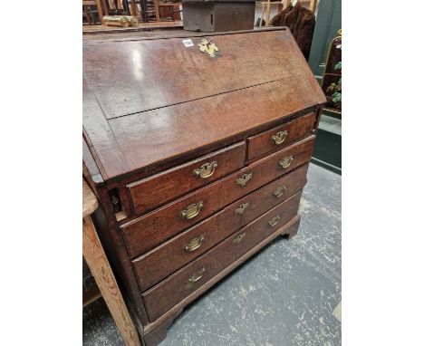 A Georgian country oak bureau togethr with a mahogany wall shelf.