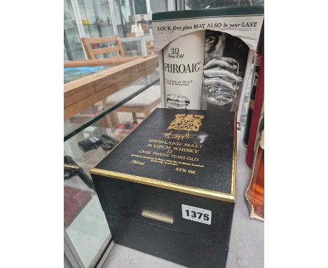 A bottle of Argyll Highland Malt Scotch Whiskey and a bottle of Laphroaig Whiskey. 