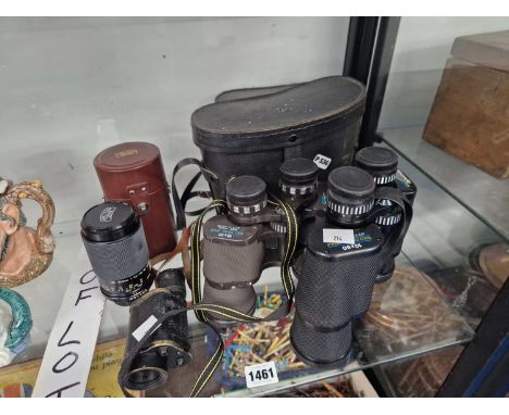 Two pairs of binoculars, a monocular together with a camera lens