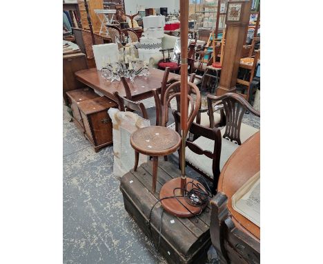 A retro standard lamp, a mirror, a child's chair and a tin trunk.