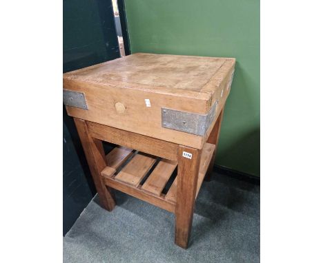 A vintage butchers block on stand.