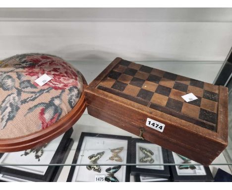 A wooden chess set boxed within its board and together with a footstool