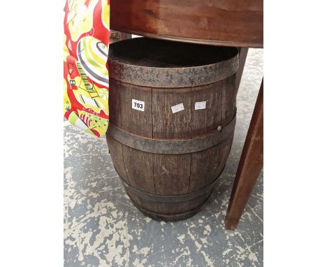 A vintage barrel and a leather upholstered stool.