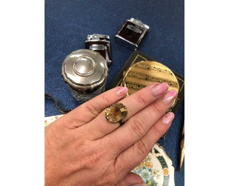 A vintage gem set cocktail ring. The raised setting with a deep rectangular facet gemstone. Unhallmarked, assessed as having 
