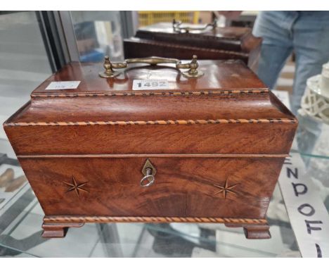 A Regency mahogany tea caddy containing three cannisters