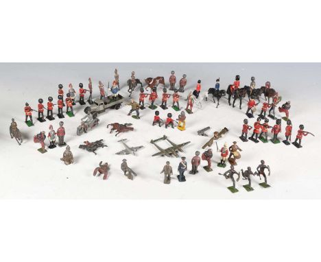 A collection of Britains and other lead figures, including Zulus running, British soldiers standing and firing, bandsmen and 