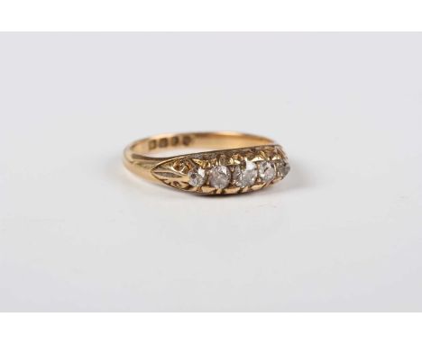 A late Victorian 18ct gold and diamond five stone ring, mounted with a row of graduated cushion shaped diamonds, London 1900,