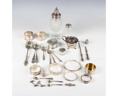 A group of silver, including napkin rings, teaspoons, three adjustable bangles, a pair of torpedo cufflinks and a Victoria 18