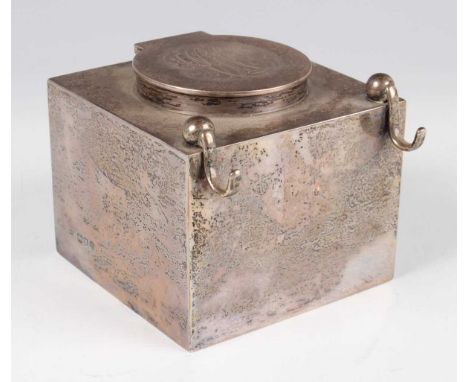 An Edwardian silver cased glass inkwell of square form with circular hinged lid and hook pen rests, London 1908 by John Grins