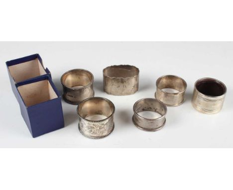 A late Victorian silver napkin ring, engraved with foliage within beaded borders, Sheffield 1900 by Martin Hall &amp; Co, tog