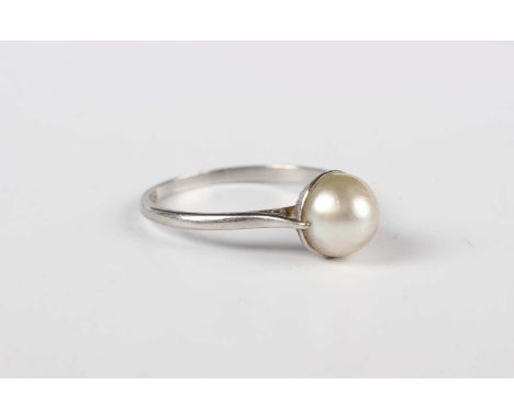 A platinum ring, mounted with a pearl, detailed ‘PLAT’, ring size approx P.