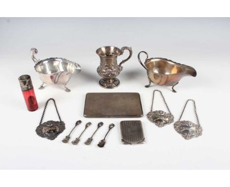 An early Victorian silver christening mug of baluster form, repoussé decorated with a band of leaves, flanked by a scroll han