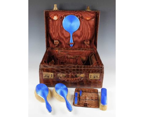 A George V silver and royal blue enamelled six-piece dressing table set, comprising hand mirror, two hairbrushes, clothes bru