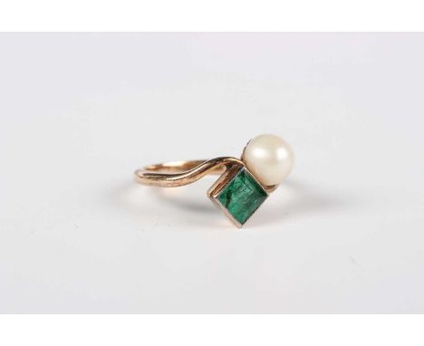 A gold, emerald and cultured pearl ring, mounted with a square step cut emerald and a single cultured pearl in a twistover de