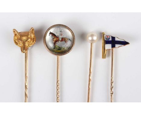 A gold fox head stickpin, total weight 3.8g, width of finial 1cm, with a case, detailed ‘Collingwood (Jewellers) Ltd…’, a gol