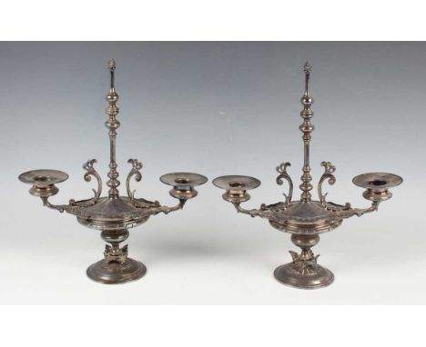 A pair of late 19th century plated Etruscan style twin-branch candelabra, height 28cm, a plated four-piece tea set and a part