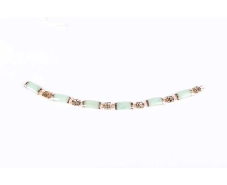 A 9ct gold mounted jade bracelet, formed as a row of curved jade panels alternating with gold character motifs, detailed ‘9K’