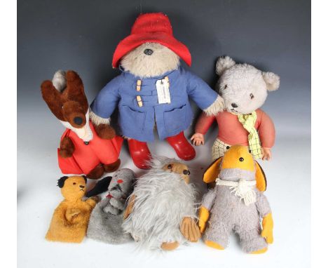 An Eden Paddington Bear, wearing a red hat, blue duffle coat and red boots, height 45cm, and a Paddington carry case, togethe