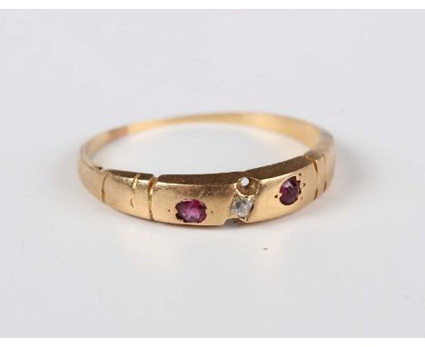A gold, ruby and diamond three stone ring, mounted with a small cushion shaped diamond between two rubies, weight 1.8g, ring 