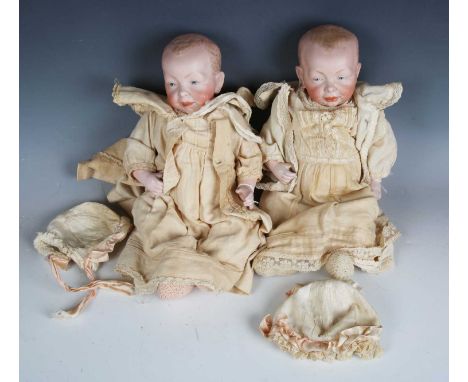 A pair of Kammer &amp; Reinhardt bisque head character dolls, impressed '36 100', with painted features, open mouths and bent