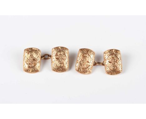 A pair of gold curved rectangular cufflinks with foliate and scroll engraved decoration, detailed ‘15ct’, weight 7.1g, dimens