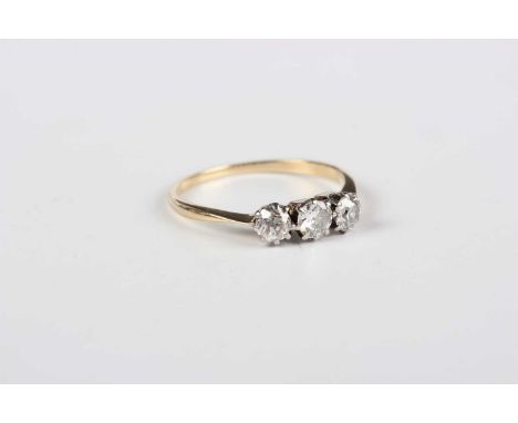 A gold and diamond three stone ring, claw set with a row of old cut cushion shaped diamonds, weight 1.5g, ring size approx L,