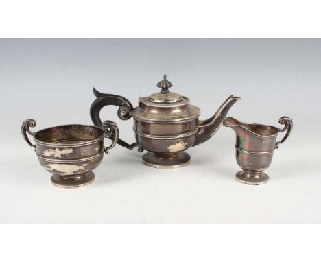 An Edwardian silver three-piece bachelor's tea set of circular girdled form, comprising teapot, two-handled sugar bowl and mi