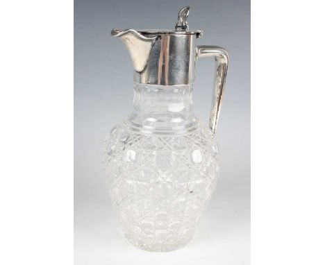 A late Victorian silver mounted cut glass claret jug, the silver hinged lid, collar, spout and angled handle above a hobnail 