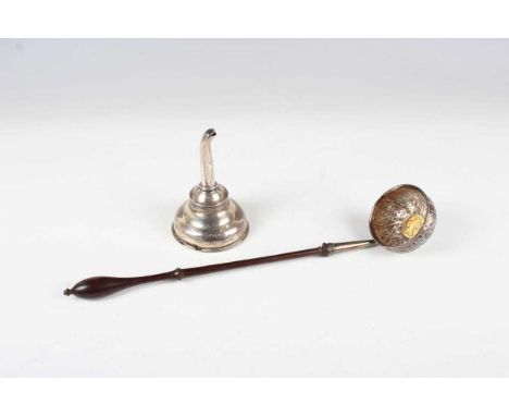 An 18th century silver punch ladle, the circular bowl chased with flowers and leaves, inset with a Queen Anne shilling 1711, 