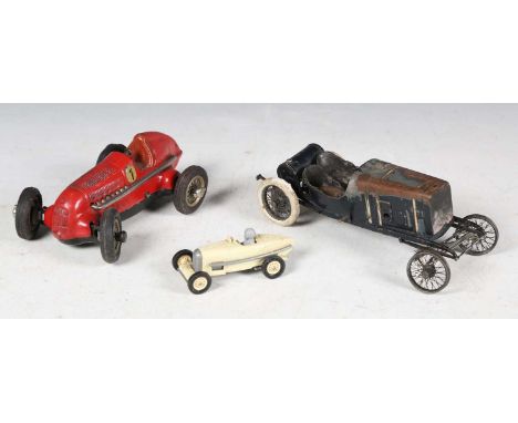 A Schuco Studio tinplate clockwork racing car in red with race number 1, a wood and brass model of a vintage racing car, leng