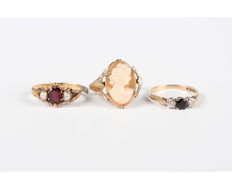 A Victorian gold ring, mounted with a central garnet between two half-pearls (shank split), a gold and oval shell cameo ring,
