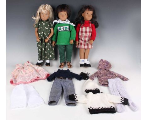 A Sasha vinyl boy doll wearing a green jumper, trousers and sandals, height 41cm, together with two Sasha girl dolls, height 