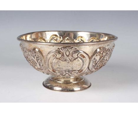 An Edwardian silver circular rose bowl, embossed with flowers, 'C' scrolls and stylized scallop shells, presentation engraved